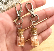 Load image into Gallery viewer, Pink Himalayan Salt keychain- pink Himalayan salt crystals in a glass bottle glued with lobster clasp hook keychain
